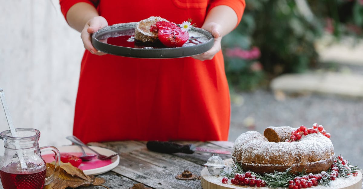 Homemade Dressing [duplicate] - Crop unrecognizable female in red dress demonstrating plate with palatable homemade pie garnished with pear and chamomile flower while standing in backyard