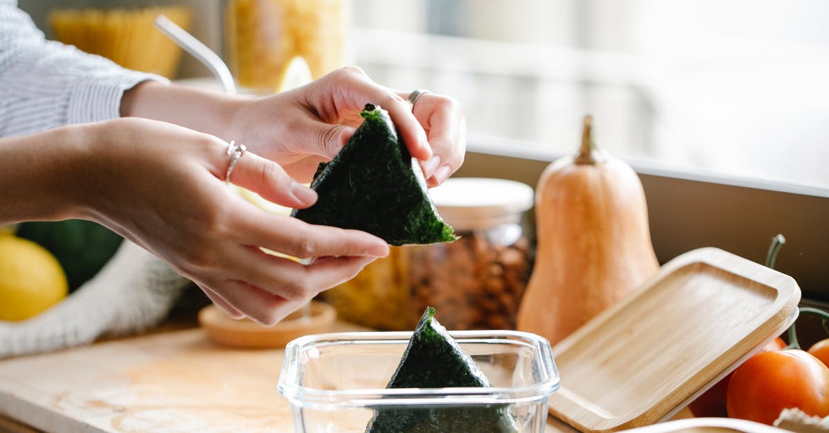 Homemade nori -> aonori? - Unrecognizable woman with onigiri at kitchen counter