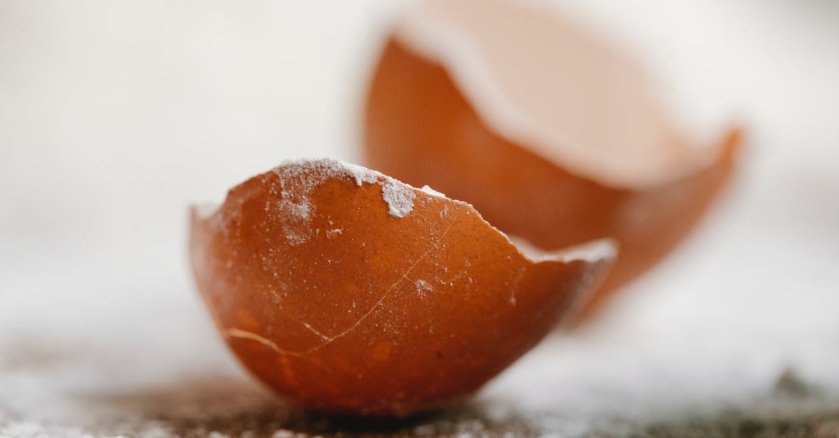 Homemade powdered jello recipe - Closeup of broken eggshell placed on table with scattered flour in kitchen for cooking