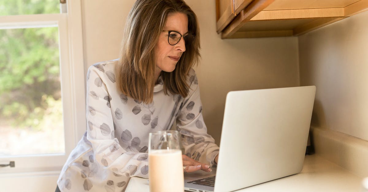 Home-made soy milk - Woman Using Gray Laptop Computer in Kitchen