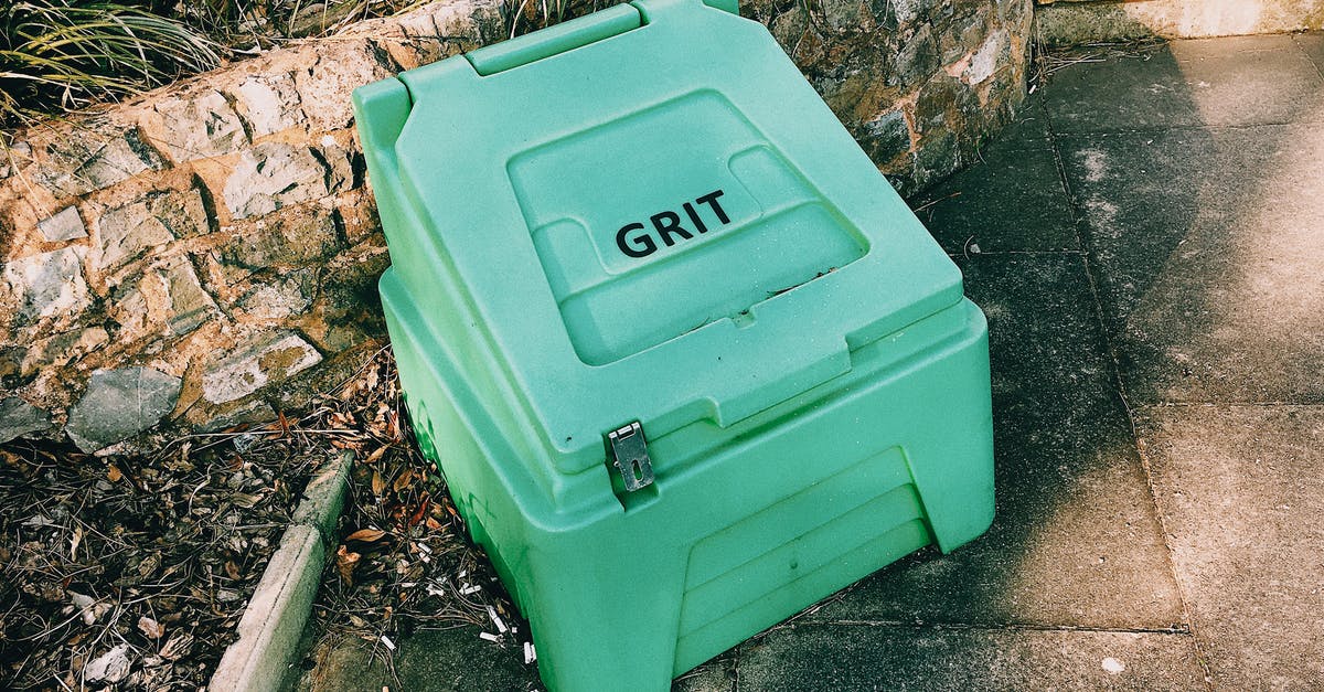 hominy grits versus masa harina - Container near stone barrier on street