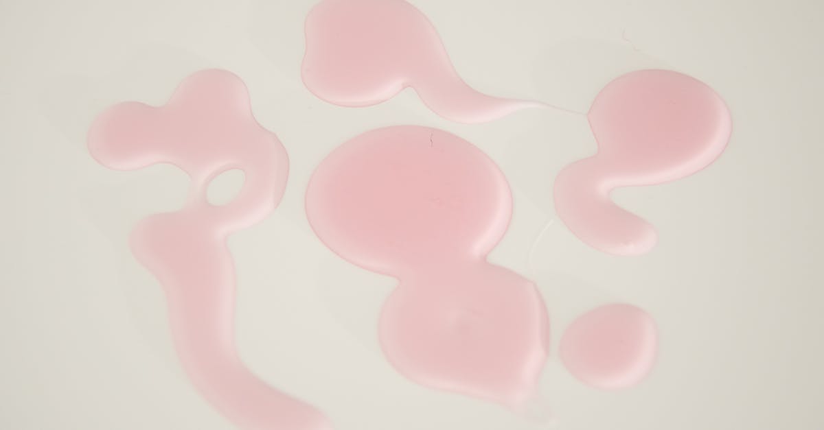 Hot pink spots on surface of ham steak - Textured background of gel drips on white surface