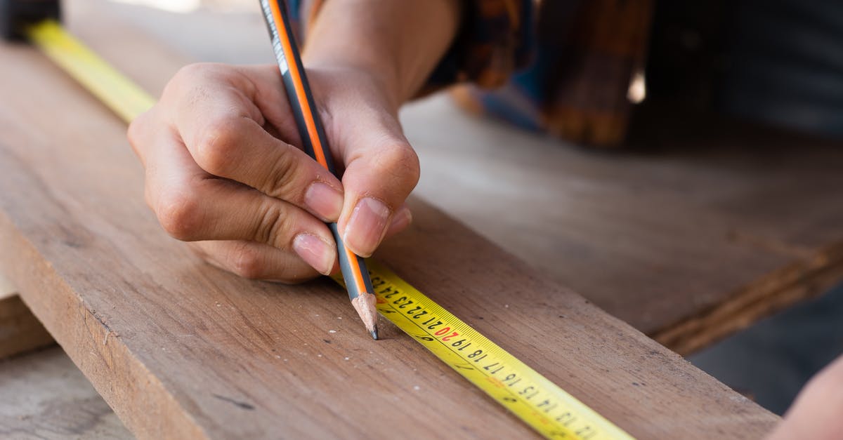 How accurate is the hand technique for grilling? - Woman Measuring with Yellow Pencil on Board