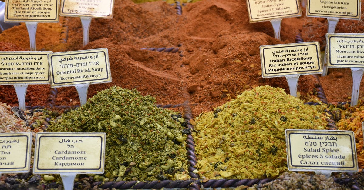 How are jasmine and basmati rice related, how are they different? - From above of collection of colorful aromatic dry condiments with titles in street market