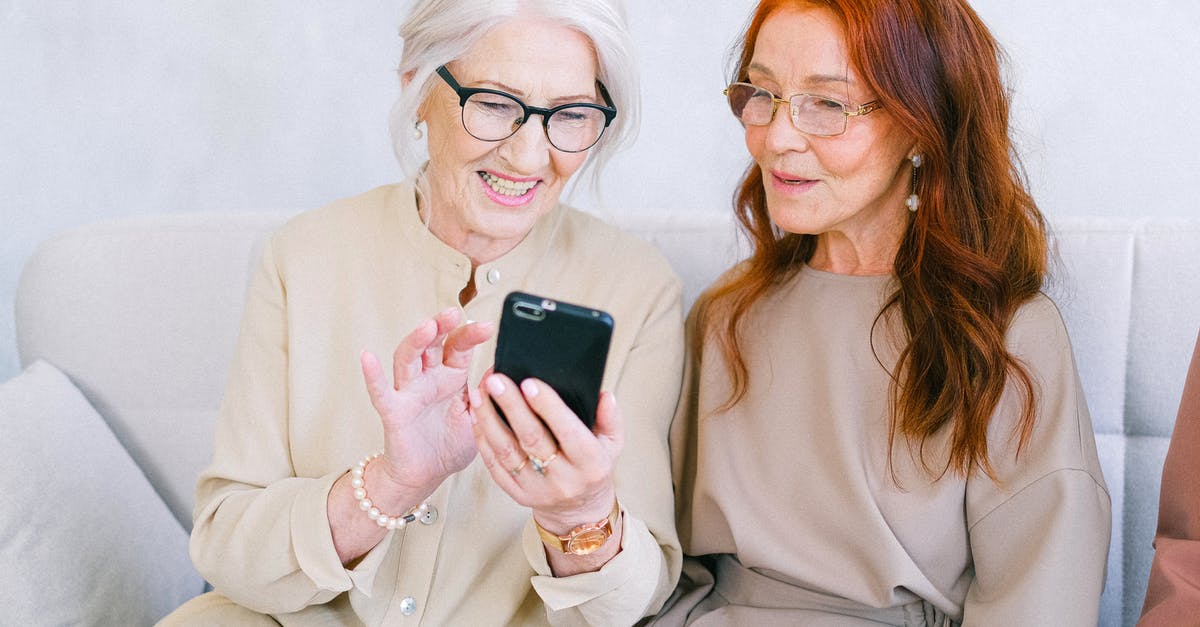 How best to use gluten free all purpose flour? - Happy elderly elegant trendy women looking at screen of mobile phone and shopping online while resting on sofa