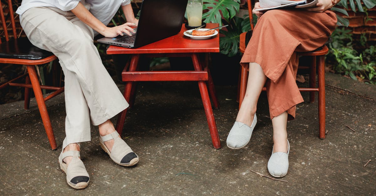 How best to use gluten free all purpose flour? - Crop anonymous female using laptop and sitting near friend reading magazine on terrace of cafe in daytime