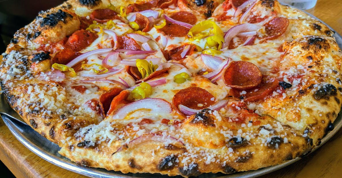 How can huge bubbles in pizza crust be prevented? - Pizza With Pepperoni and Cheese