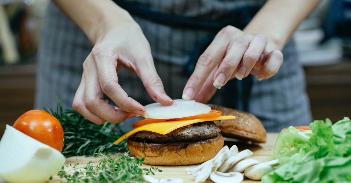 How can I add meat into a completed tomato sauce? - Crop woman preparing burger in kitchen