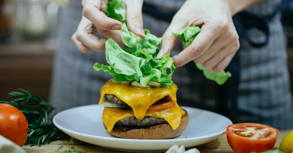 How can I add meat into a completed tomato sauce? - Crop woman cooking burger at table