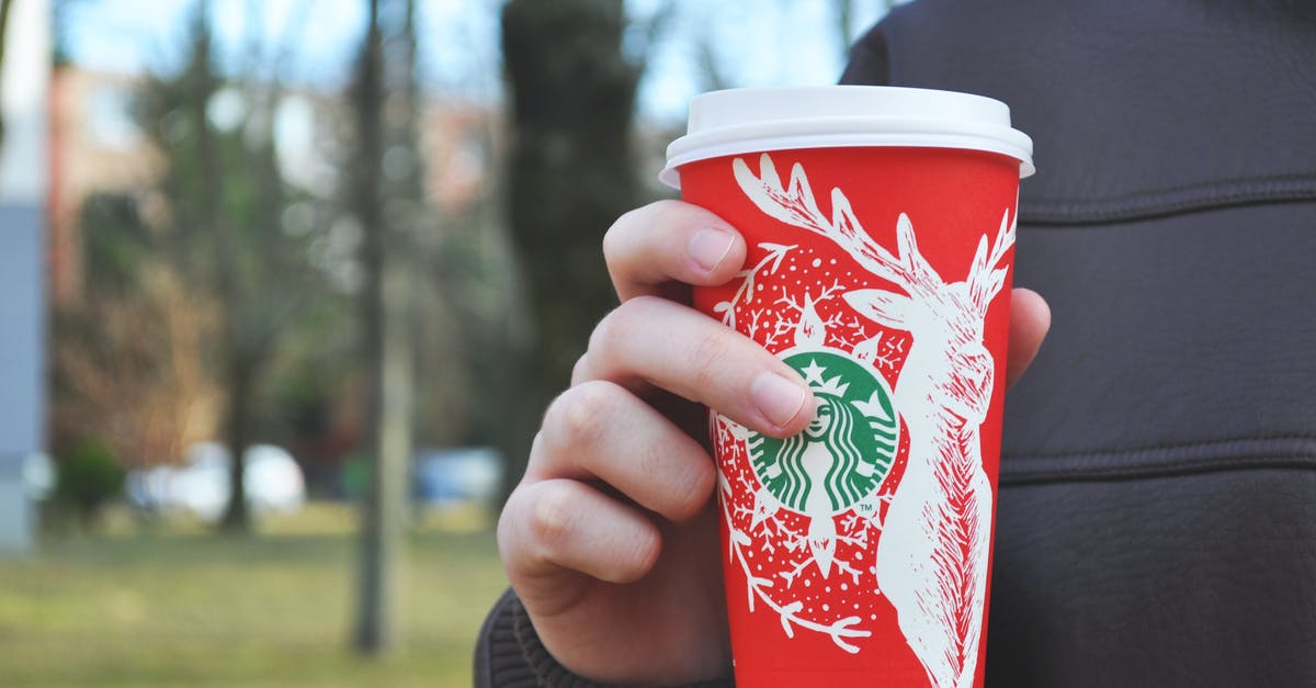 How can I approximate a Starbucks latte at home? - Person Holding Starbucks Disposable Tumbler