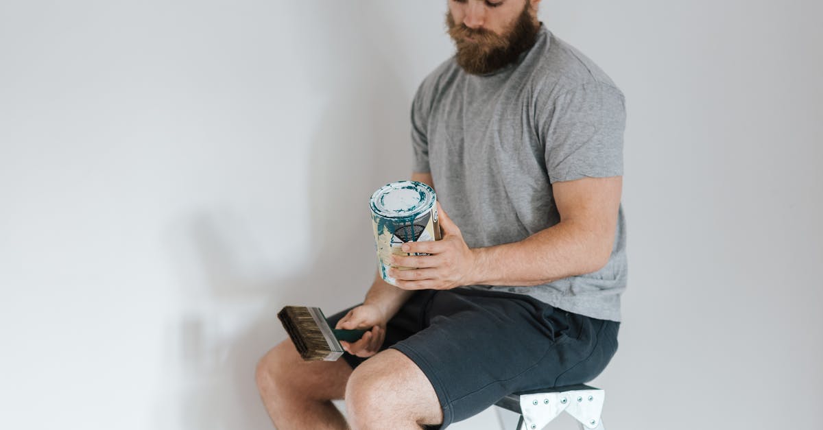 How can I clean chia seeds? - Crop hipster man with can on paint on ladder