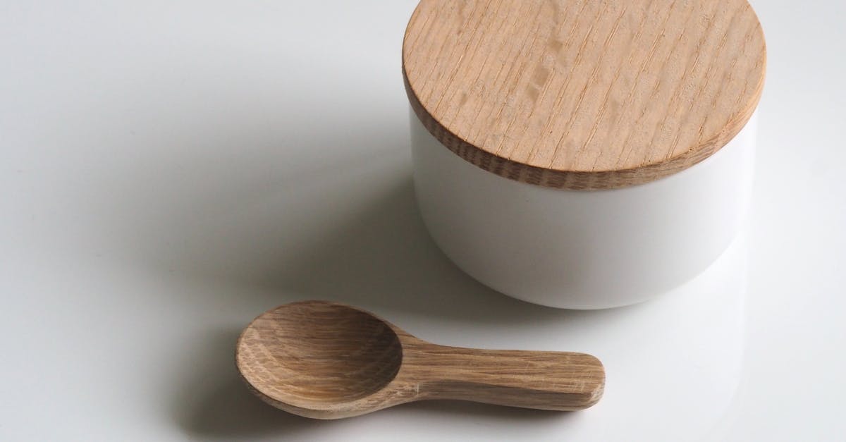 How can I clean this cooking pan? - Close-up Photography of White and Brown Wooden Container and Spoon