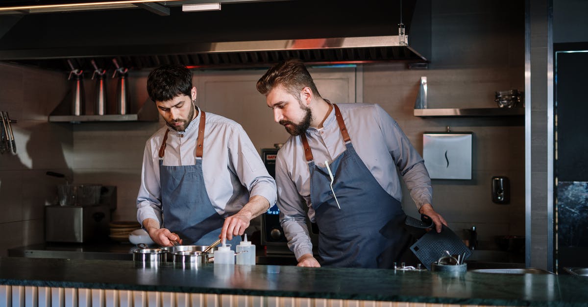 How can I cook a perfect deep-fried Mars bar? - Man in White Dress Shirt Standing Beside Man in Gray Vest