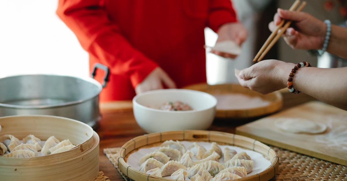 How can I cook my dumplings without a bamboo steamer? - Crop relatives filling dim sum in kitchen