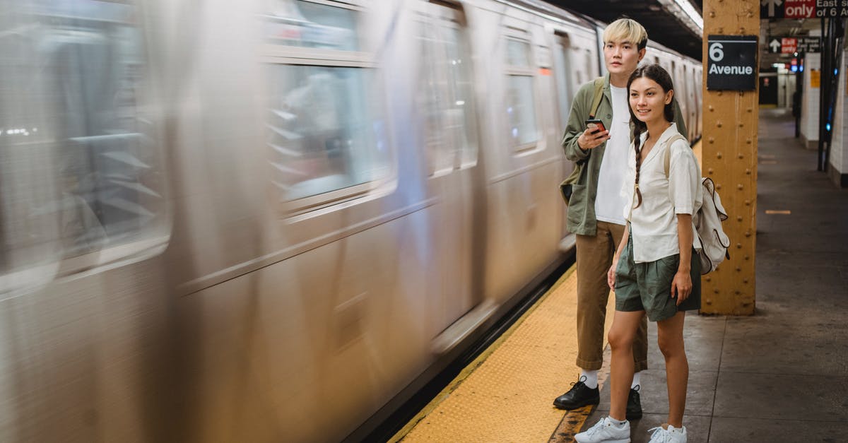 How can I cool chocolate in a couple of minutes? - Young trendy ethnic passengers waiting for train on platform