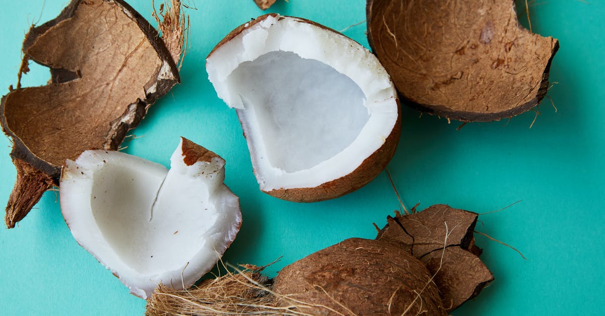 How can I create this coconut milk, fruit, and veggie snack at home? - Pieces of cracked coconut with aromatic white pulp