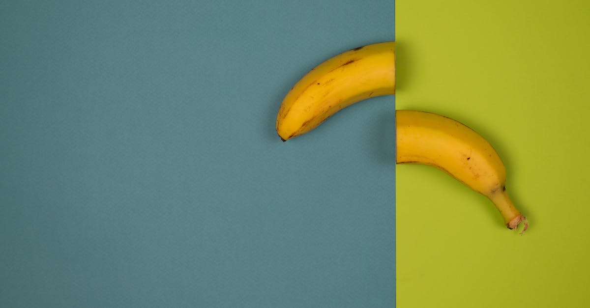 How can I cut fudge smooth and uniform? - Overhead view of delicious cut fresh banana with stem and spots on peel on smooth surface