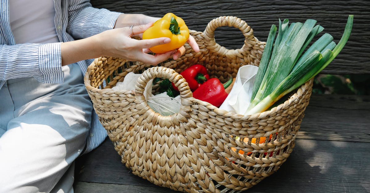 How can I fix a bitter raw leek soup? - Crop unrecognizable woman placing fresh vegetables in basket in garden