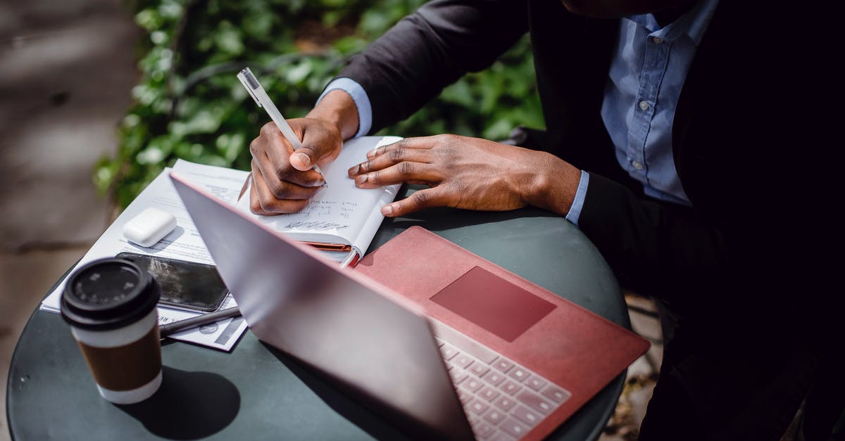 How can I get a takeaway style pizza base? - From above of crop black male journalist in formal wear writing article while sitting at table with red laptop and cup of takeaway coffee