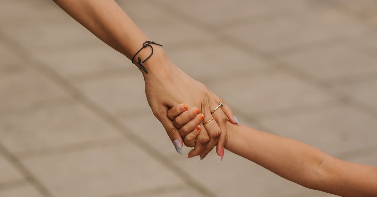 How can I get unsweetened gluten-free chocolate brownies to hold together? - Crop anonymous woman wearing elegant engagement ring holding hand with child on street in daytime