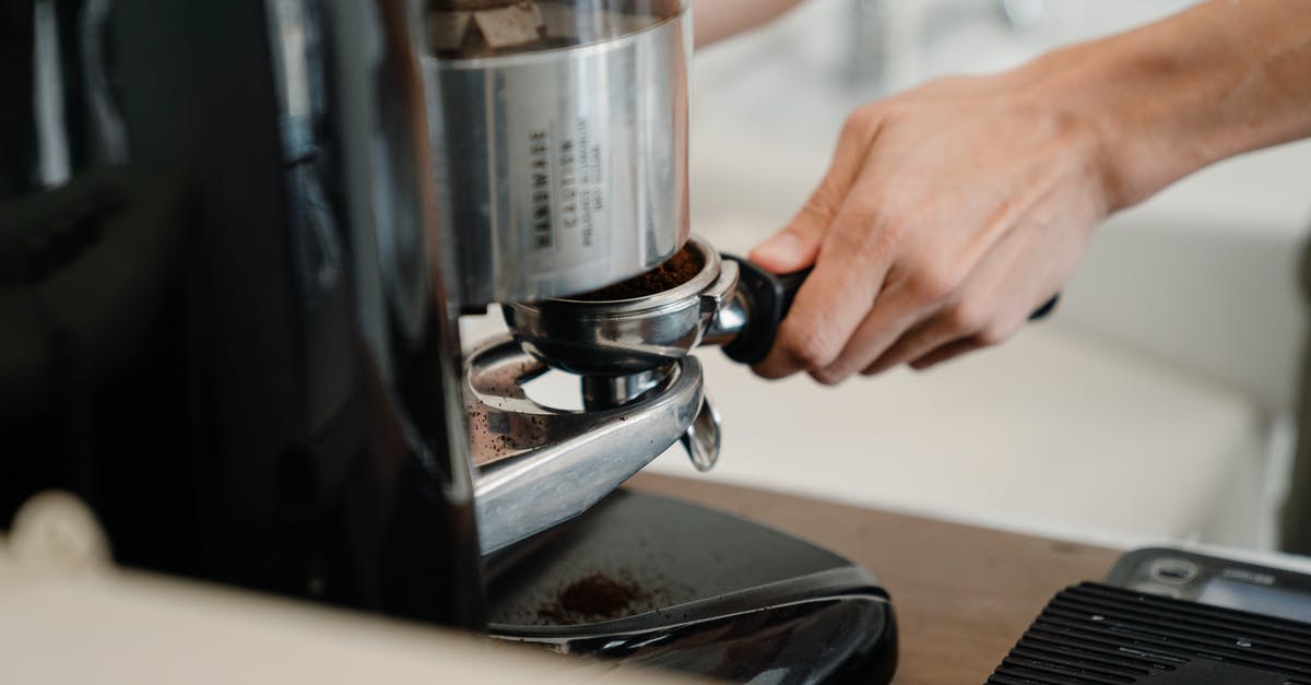 How can I grind coffee without a coffee grinder? - Crop person preparing coffee with machine