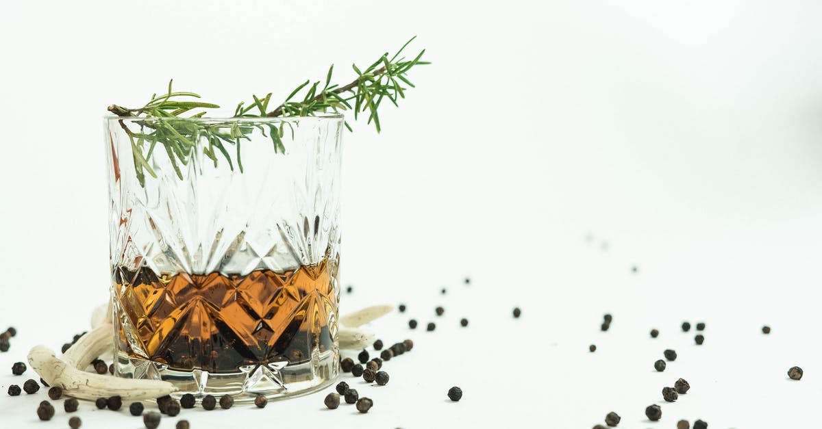 How can I infuse alcohol with 'fragile' herbs? - Glass of whiskey near peppercorns