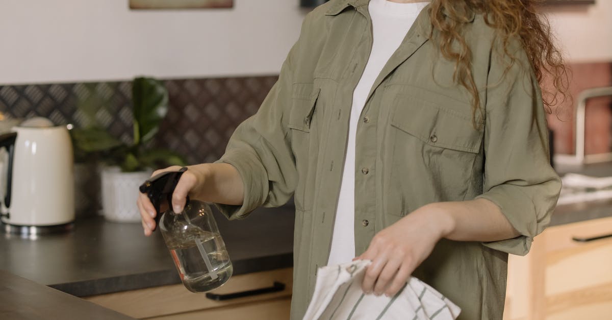 How can I keep flies out of my kitchen? - Woman in Gray Coat Holding Clear Glass Mug