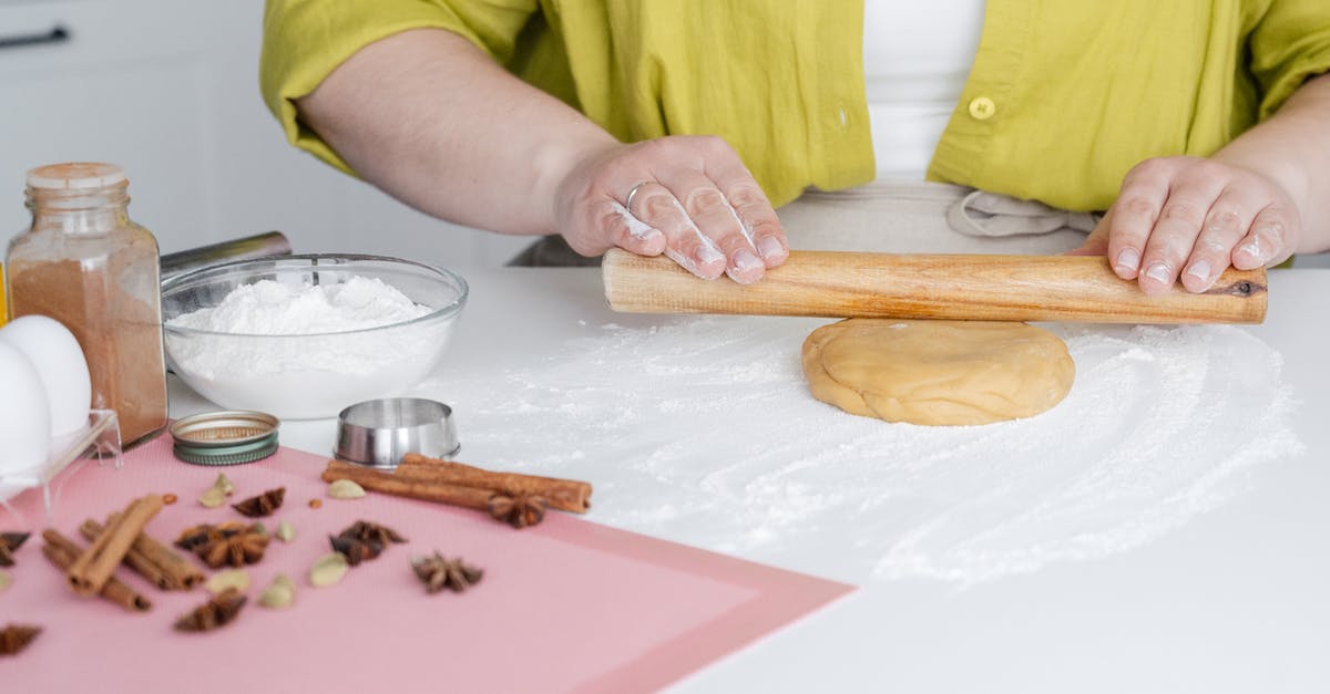 How can I make seitan sausages from a homemade seitan block? - Unrecognizable woman rolling dough on table