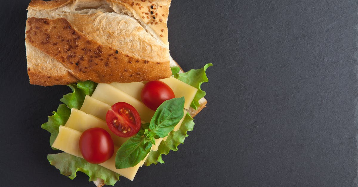 How can I minimize "stringing" of cheddar cheese - A Bread Near the Cheese with Tomatoes on Top