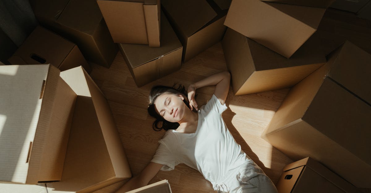 How can I move from subscription boxes to recipes successfully? - Woman in White Long Sleeve Shirt Lying on Brown Cardboard Box