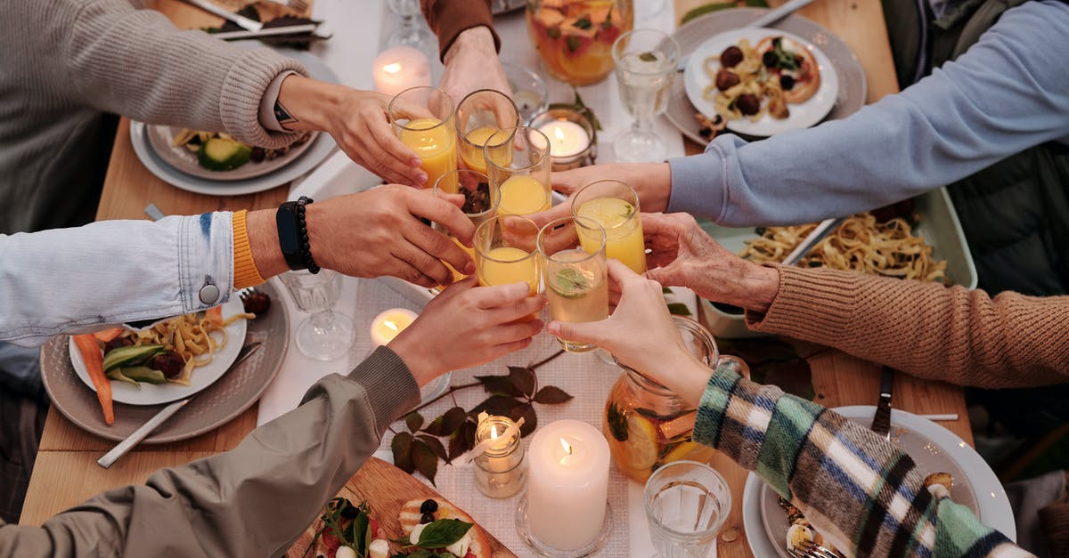 How can I prevent my texas toast from sticking together? - From above of crop friends enjoying dinner with candles while cheering with glasses of drinks