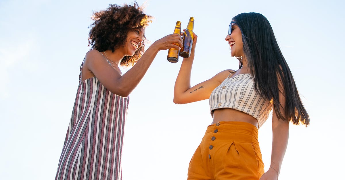 How can I prevent my texas toast from sticking together? - Low angle of delighted multiracial female friends toasting with bottles of beer while laughing together during party