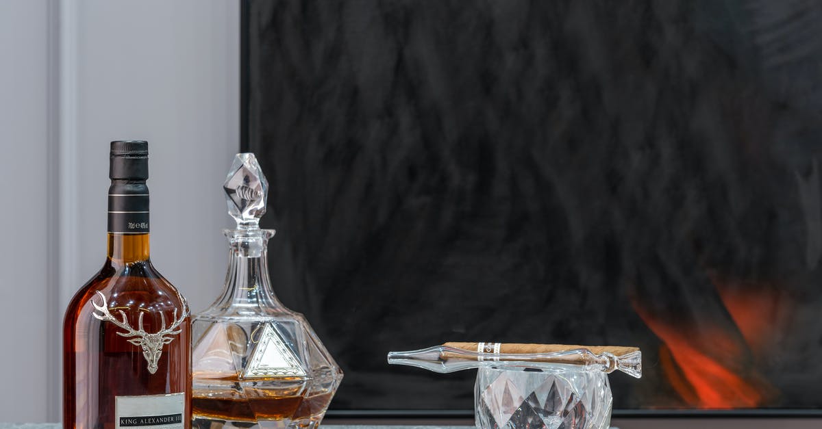 How can I remove a stuck liquor decanter stopper? - Bottle and decanter with expensive alcoholic drink near ornamental glass with cigar in house room