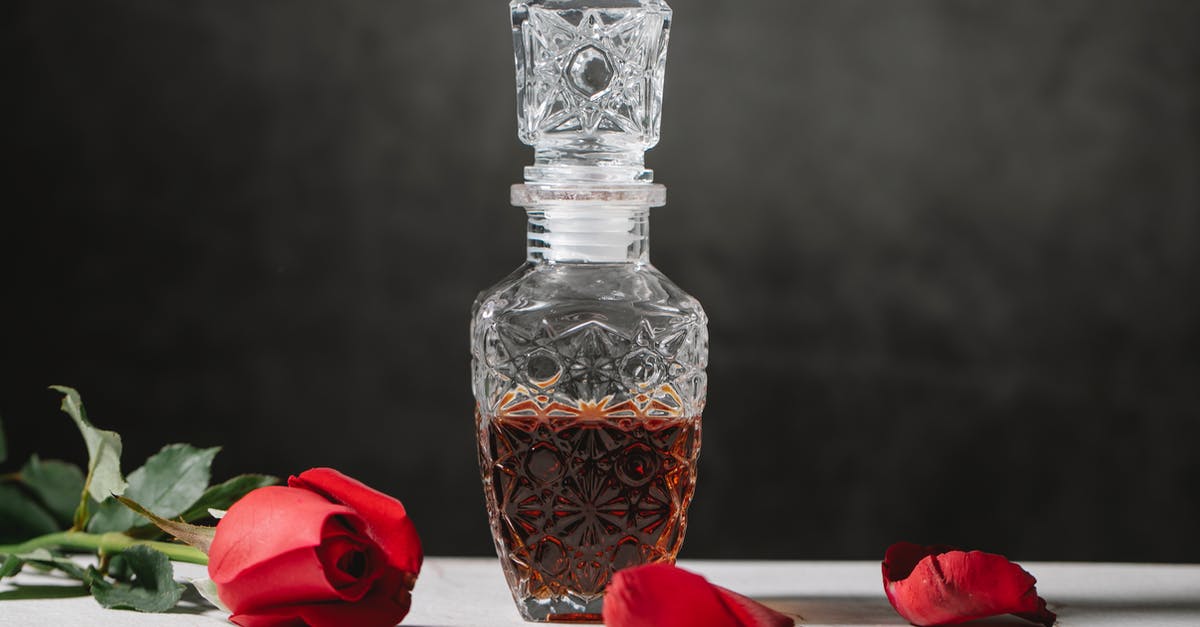How can I remove a stuck liquor decanter stopper? - Bottle of bourbon on table with rose