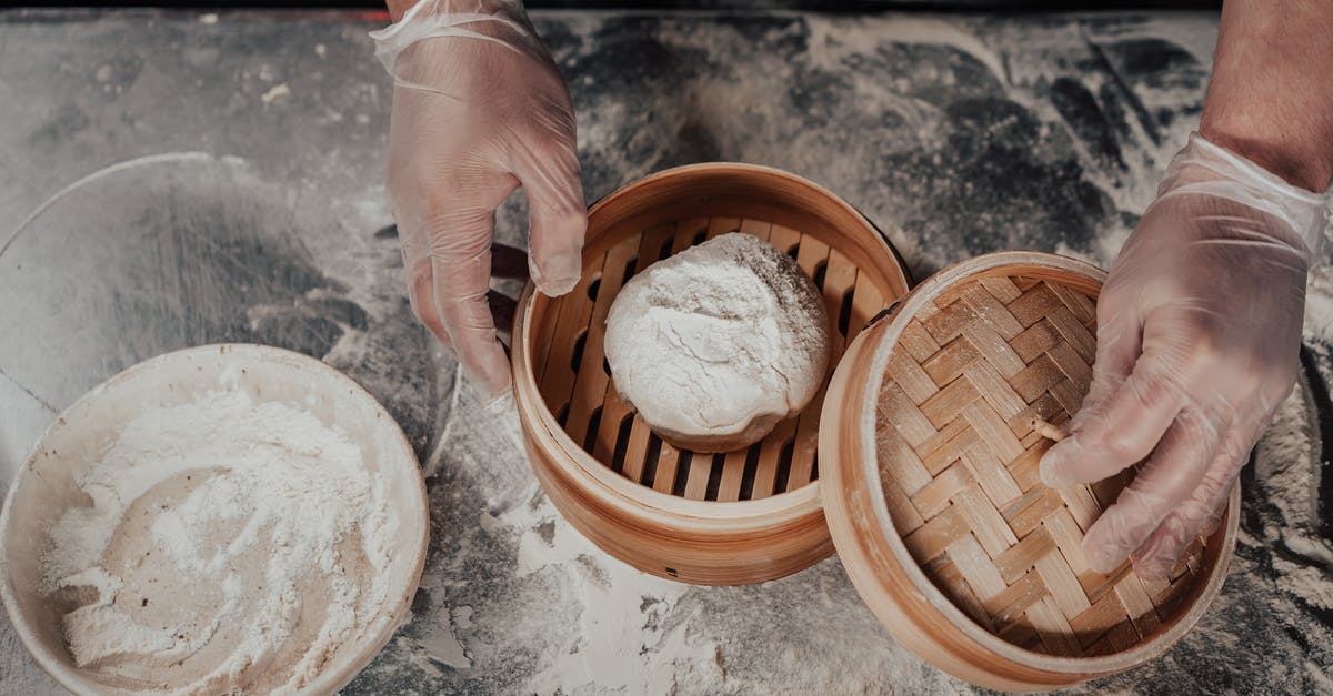 How can I warm bread making ingredients to room temperature?  - Person Holding Brown Wooden Round Container With White Powder