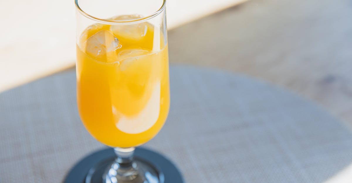 How can one clarify orange juice to clear orange flavoured gelatine? - Glass of cold yellow drink for refreshing