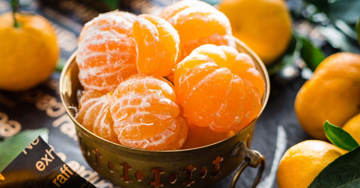 How can one clarify orange juice to clear orange flavoured gelatine? - Close-up of Fruits in Bowl