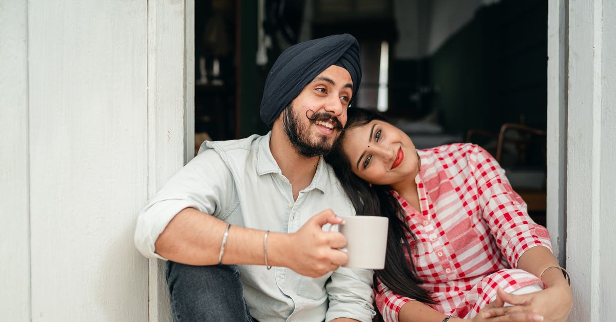 How can you tell when flour has gone off? - Positive married couple relaxing on threshold of house