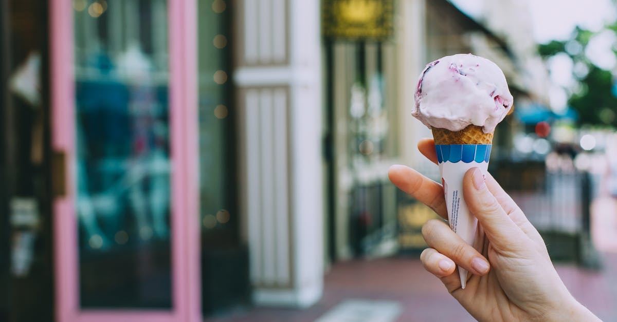 How could I keep one-ingredient "ice cream" soft? - Crop person showing delicious ice cream cone on street