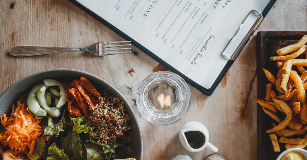 How could I make stuffed french fries? - Salad bowl and french fries served on table in cafe