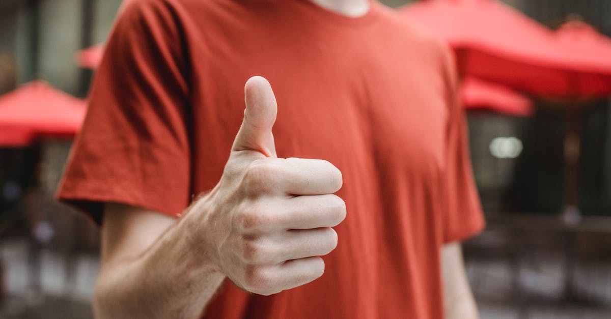 How did my Turkish Delights/lokum end up tasting like orange? - Crop anonymous young male in red t shirt showing thumb up gesture while standing on city street on sunny day