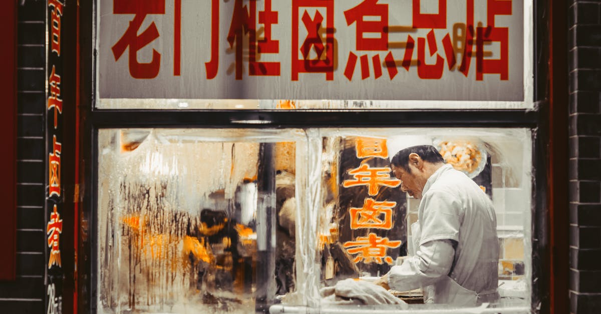 How do Chinese restaurants tenderize their meat? - Man Working Inside The Kitchen