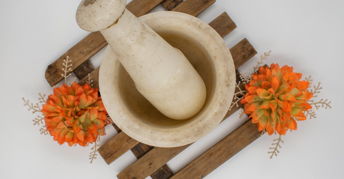 How do cooking utensils remain safe for use? - White Pestle on Brown Wooden Board with Orange Flowers