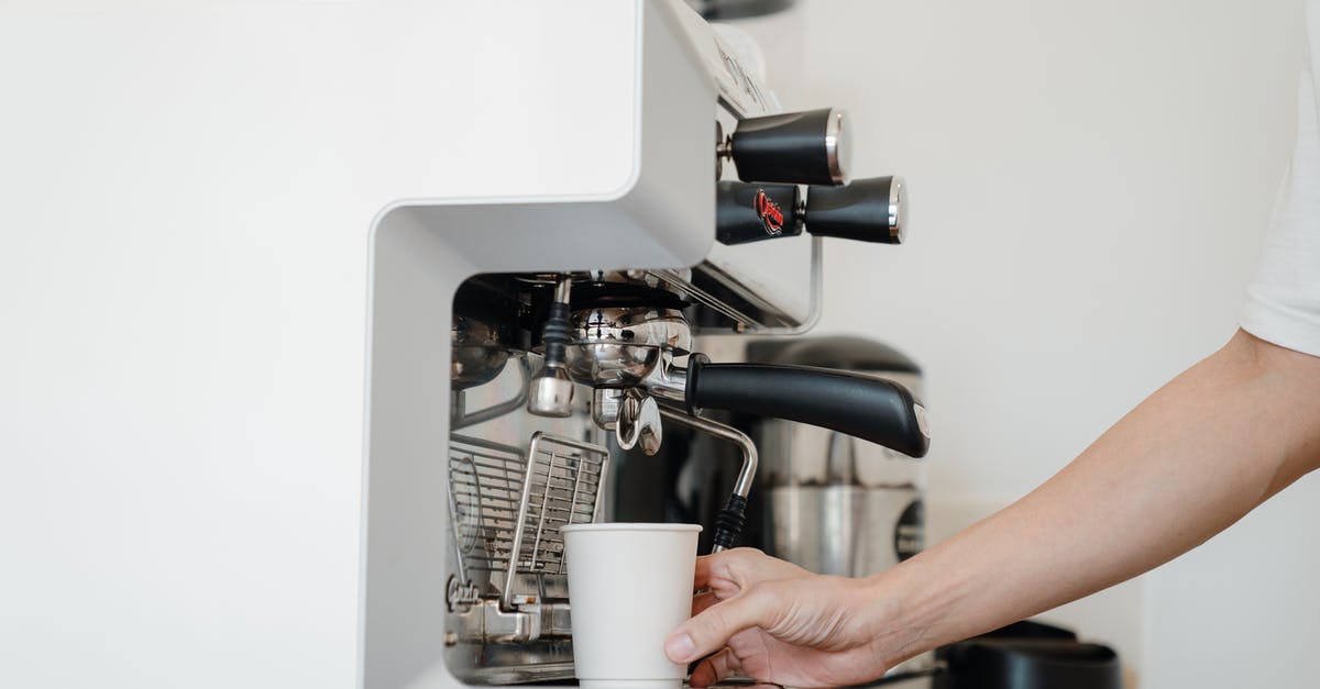 How do espresso machines hold pressure at all? - Person Holding White Cup