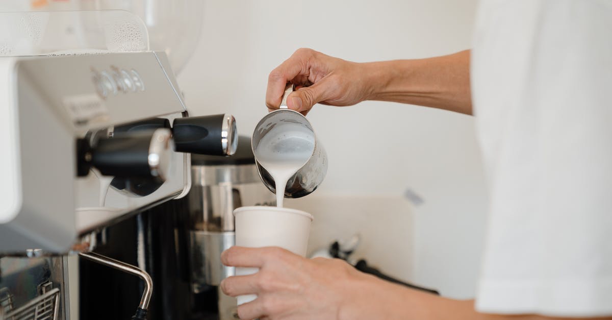 How do espresso machines hold pressure at all? - Person Pouring Milk on White Cup