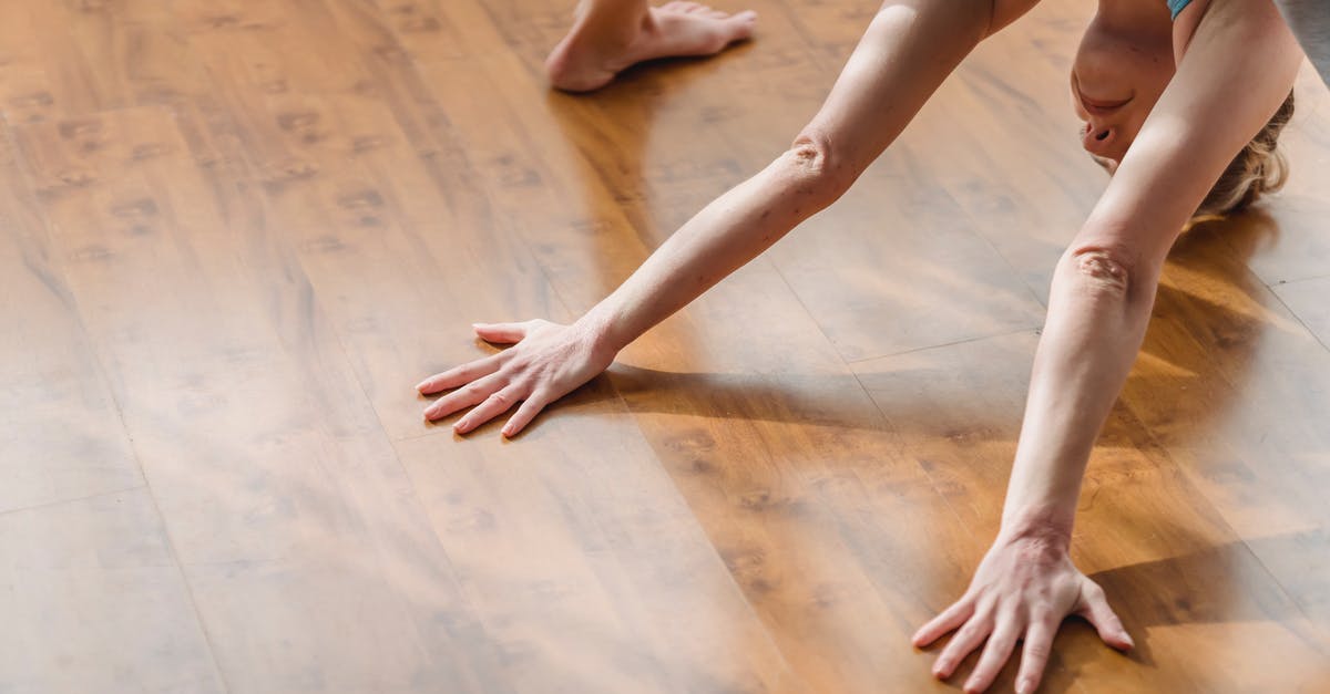 How do I balance the bitterness of raddichio in soup? - From above of concentrated young barefooted lady in activewear lengthening body while performing Wide Legged Forward Bend I asana during yoga session at home