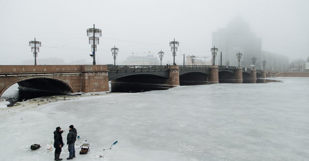 How do I choose frozen fish so that it doesn't release so much water? - Unrecognizable fishermen on river with ice