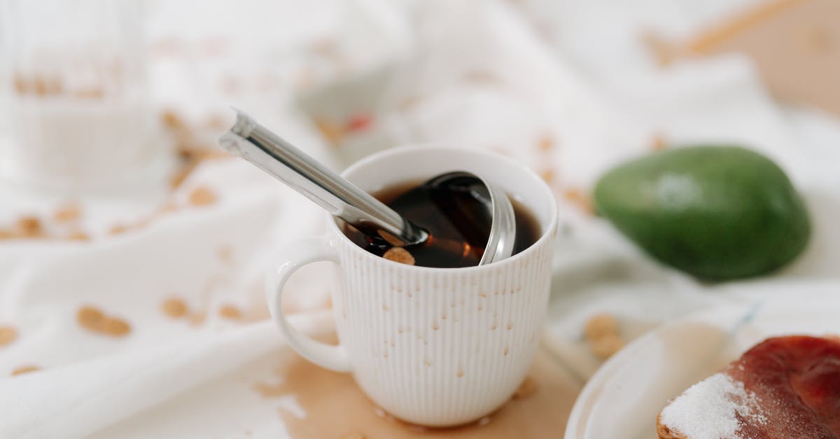 How do I choose to avoid brown stringy fibres in avocado? - An Object in a White Mug with Brown Liquid