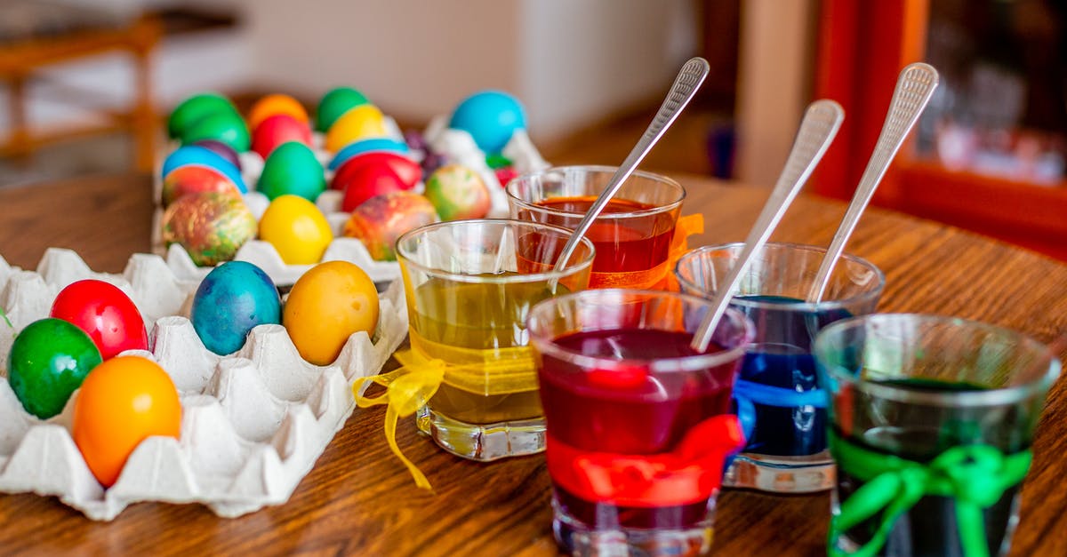 How do I color an egg black? [closed] - Clear Glasses With Colored  Liquids Beside Easter Eggs On Wooden Surface 