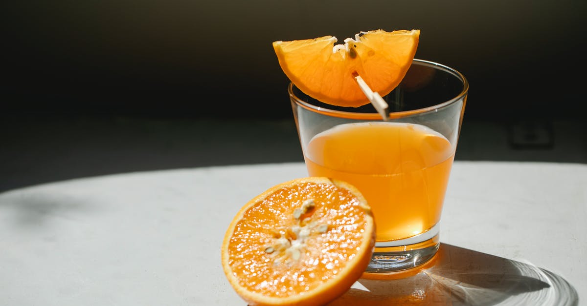 How do I concentrate the flavor in orange juice? - Orange pieces with glass of juice
